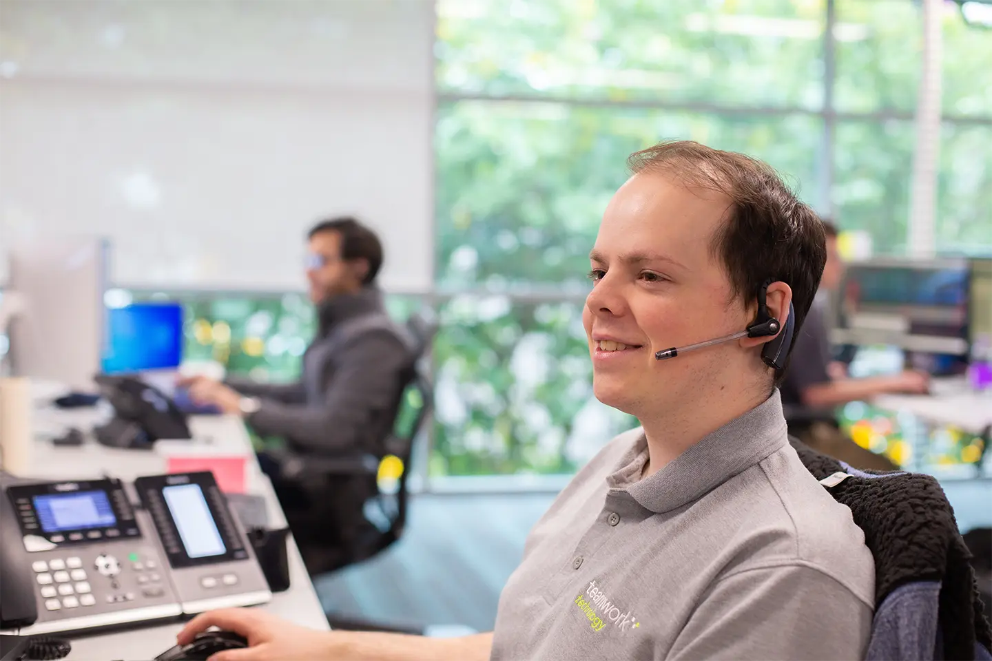 Teamwork employee on a headset speaking to clients