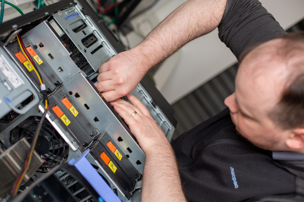 An IT technician works on a CPU.